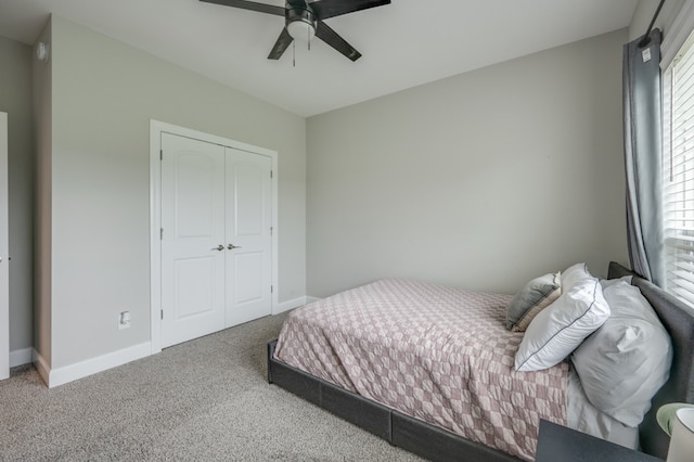 bedroom featuring carpet floors, a closet, multiple windows, and ceiling fan