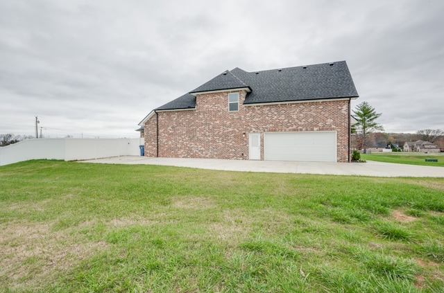 exterior space featuring a lawn and a garage