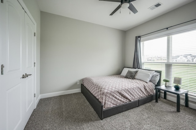 bedroom with carpet flooring, multiple windows, and ceiling fan