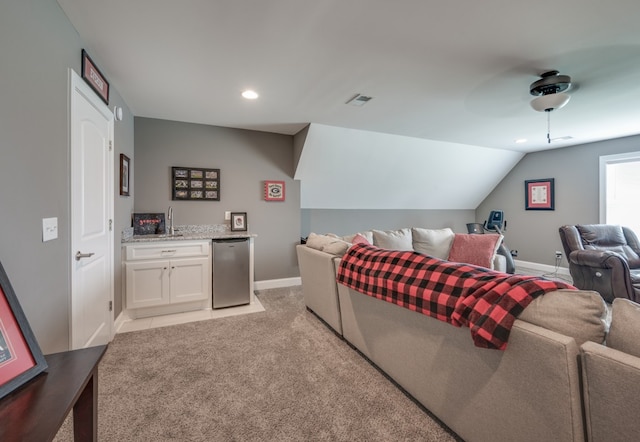 cinema featuring lofted ceiling, light carpet, and indoor bar