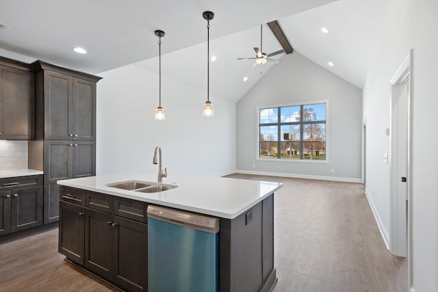 kitchen featuring ceiling fan, dishwasher, sink, light hardwood / wood-style floors, and a kitchen island with sink