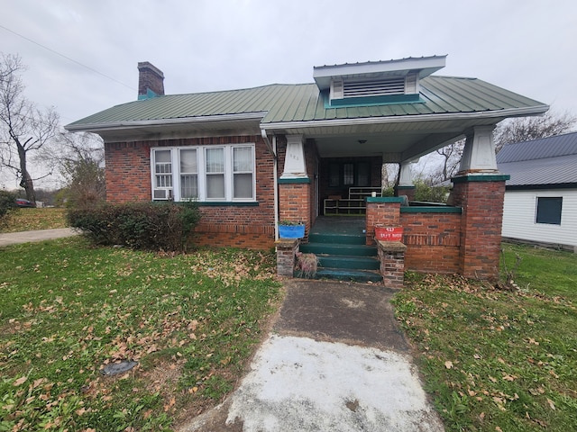 view of front of home featuring a front yard and a porch