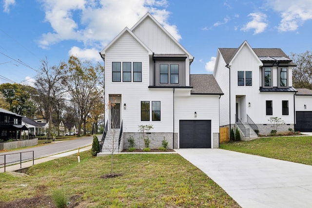 view of front of house with a front yard and a garage