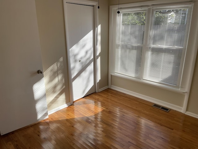 empty room with hardwood / wood-style flooring