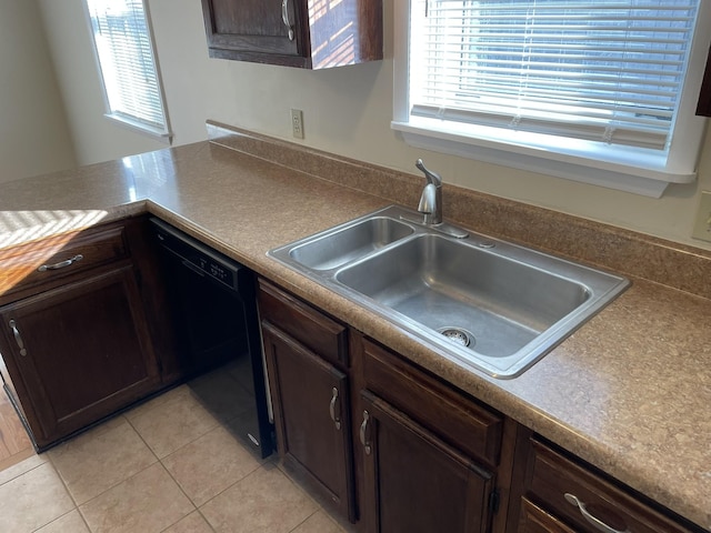 kitchen featuring a wealth of natural light, dishwasher, light tile patterned flooring, and sink