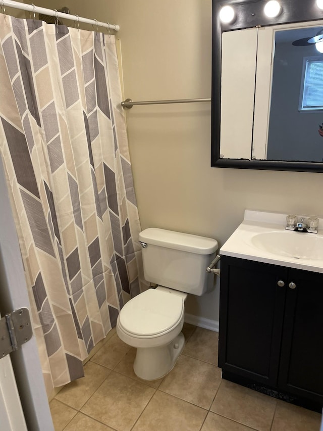 bathroom featuring tile patterned floors, vanity, and toilet