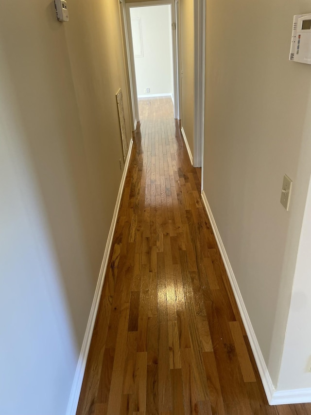 corridor featuring hardwood / wood-style floors