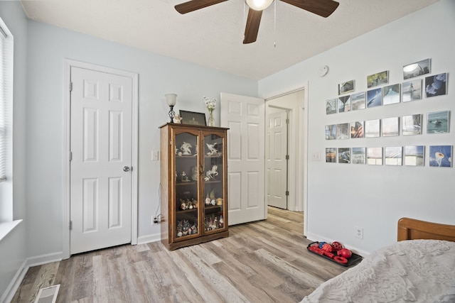 bedroom with light hardwood / wood-style floors and ceiling fan