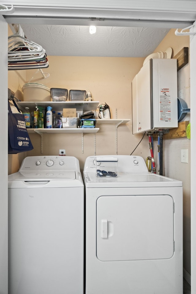 laundry area featuring tankless water heater, separate washer and dryer, and a textured ceiling