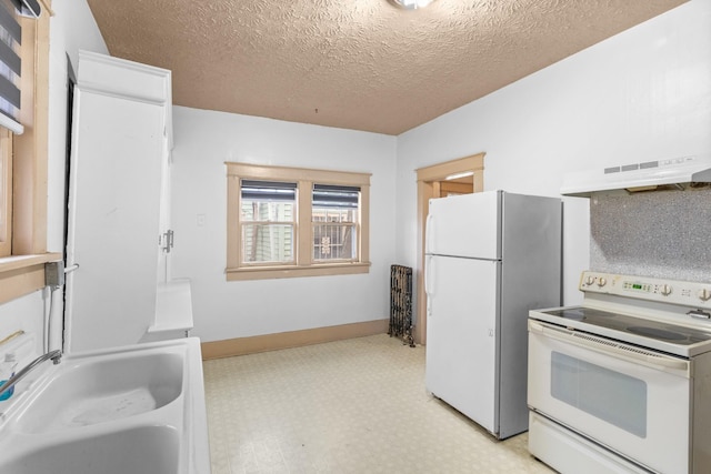 kitchen with a textured ceiling, sink, and white appliances