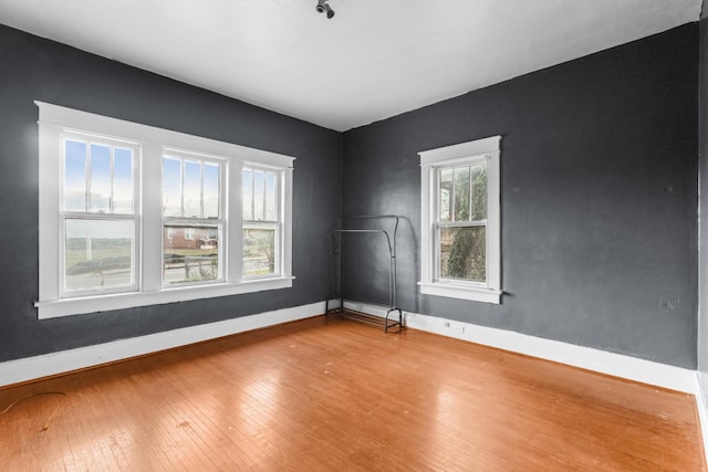 unfurnished room with wood-type flooring