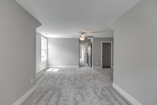 empty room with ceiling fan and carpet floors