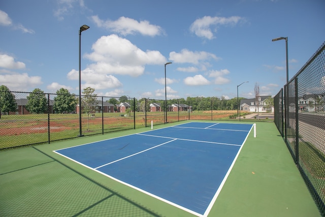 view of tennis court featuring basketball court