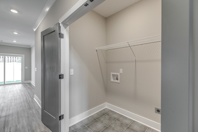 clothes washing area featuring hookup for an electric dryer, hookup for a washing machine, hardwood / wood-style flooring, and crown molding