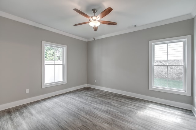 empty room featuring light hardwood / wood-style floors, ceiling fan, and crown molding