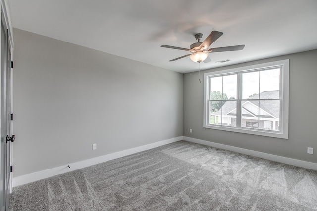 carpeted empty room featuring ceiling fan