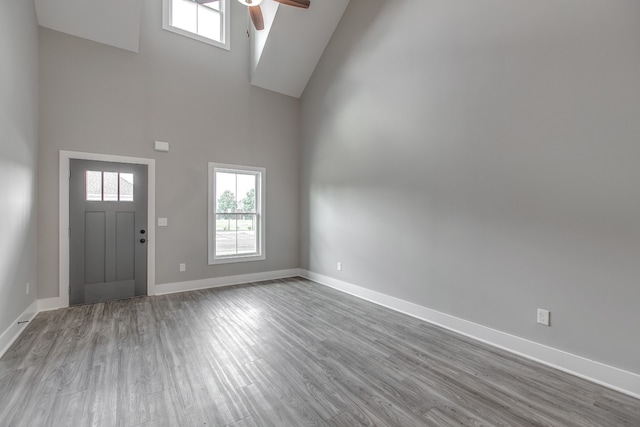 foyer with ceiling fan, light hardwood / wood-style flooring, and high vaulted ceiling