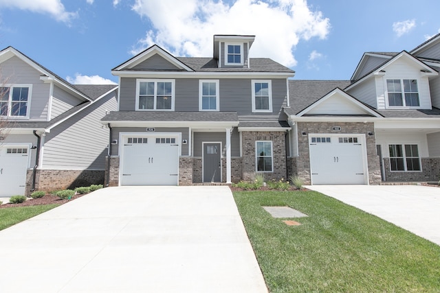 view of front of property featuring a front yard and a garage