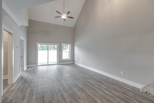 unfurnished living room featuring hardwood / wood-style flooring, high vaulted ceiling, and ceiling fan