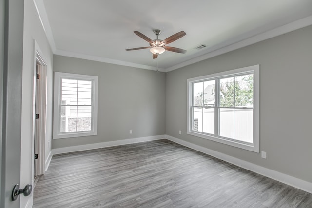 unfurnished room featuring ceiling fan, ornamental molding, and light hardwood / wood-style flooring