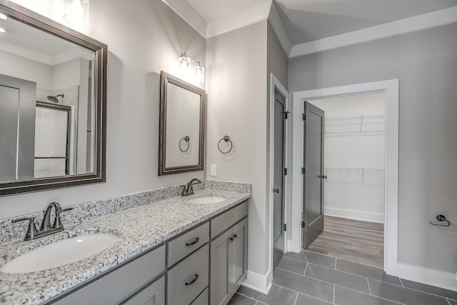 bathroom featuring crown molding, tile patterned flooring, and vanity