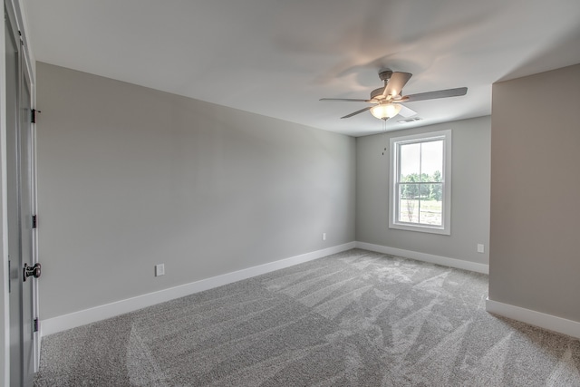 carpeted empty room featuring ceiling fan