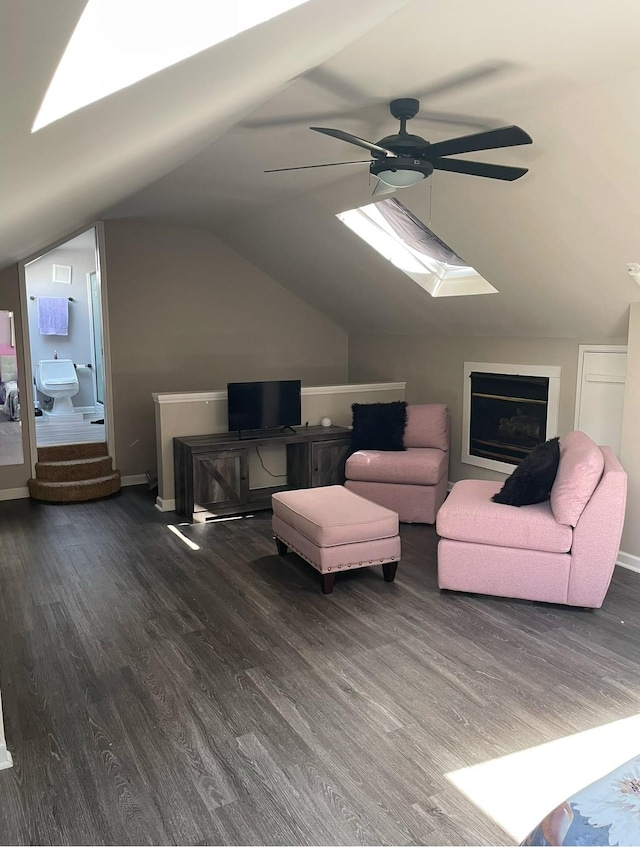 living room with vaulted ceiling, ceiling fan, and dark wood-type flooring