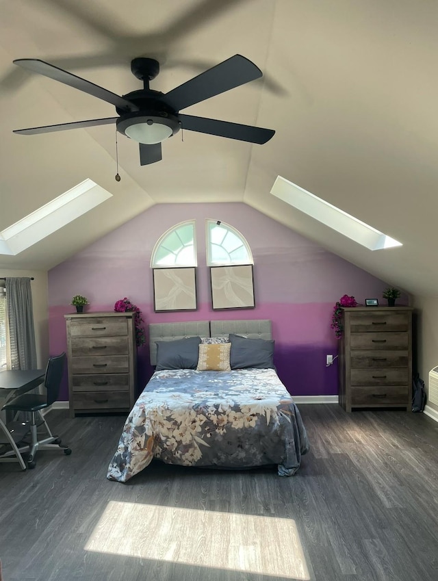 bedroom with vaulted ceiling with skylight, ceiling fan, and dark hardwood / wood-style floors