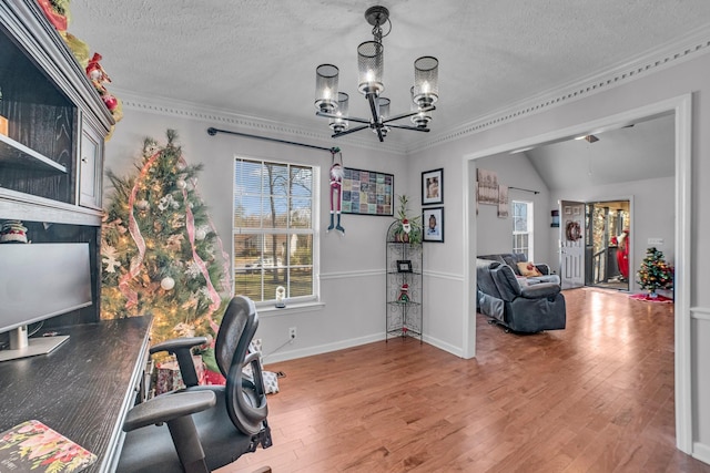 office space featuring lofted ceiling, an inviting chandelier, crown molding, hardwood / wood-style flooring, and a textured ceiling