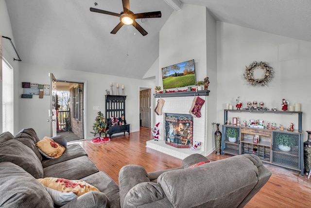 living room featuring a fireplace, beam ceiling, hardwood / wood-style flooring, and ceiling fan