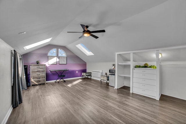 additional living space featuring hardwood / wood-style floors, ceiling fan, and lofted ceiling