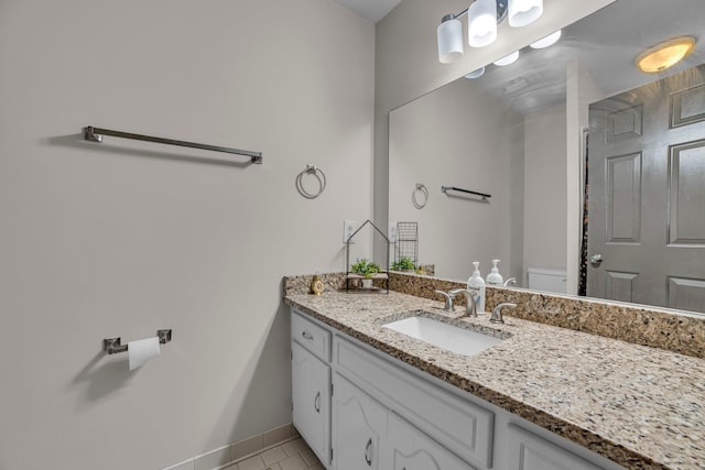 bathroom featuring tile patterned flooring, vanity, and toilet