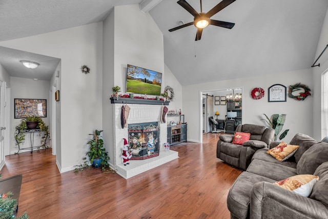 living room featuring beamed ceiling, high vaulted ceiling, wood-type flooring, a textured ceiling, and ceiling fan with notable chandelier