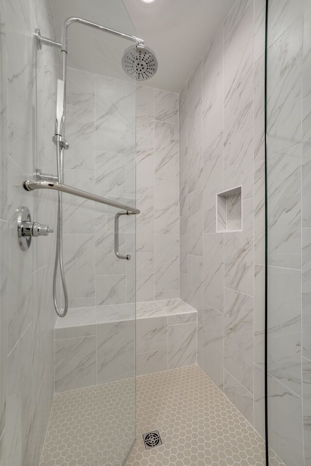 bathroom featuring a shower with door