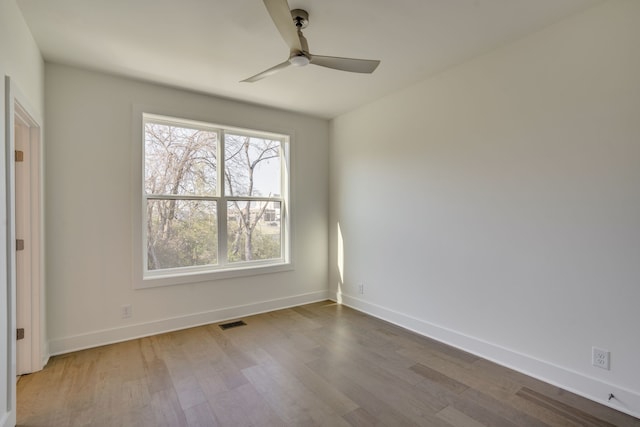 spare room featuring wood-type flooring and ceiling fan