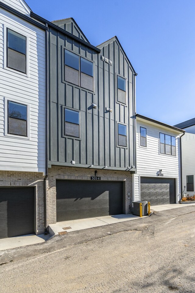 view of side of property with central AC and a garage