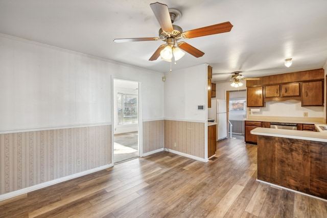 kitchen featuring stainless steel dishwasher, ceiling fan, white fridge, and light wood-type flooring