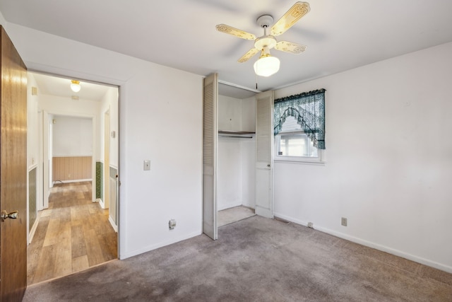 unfurnished bedroom featuring ceiling fan, a closet, and light hardwood / wood-style flooring