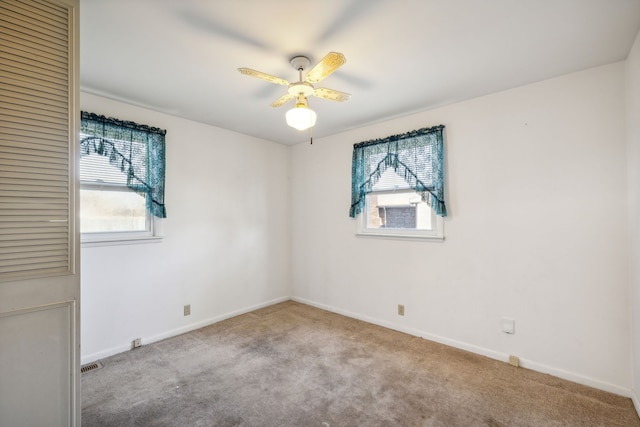 empty room featuring light carpet and ceiling fan