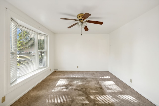 carpeted empty room featuring ceiling fan