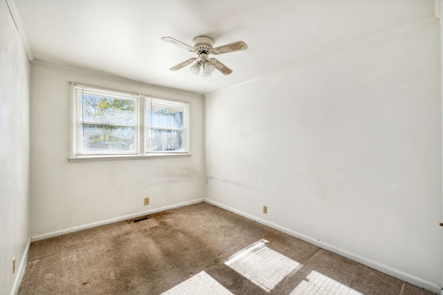 carpeted empty room featuring crown molding and ceiling fan