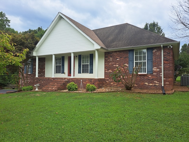 view of front of home featuring central AC, a front yard, and covered porch