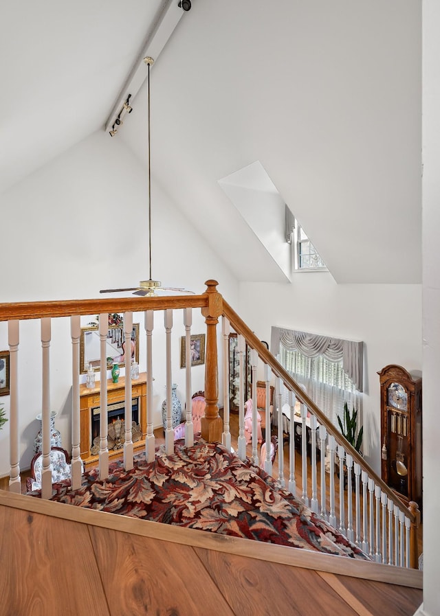 living room featuring ceiling fan, lofted ceiling, and track lighting