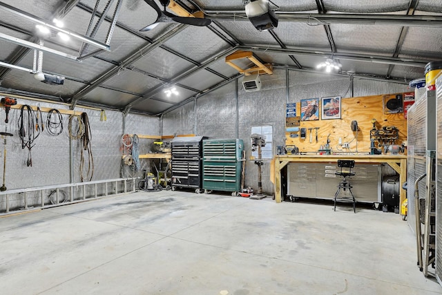 garage with a workshop area and a garage door opener