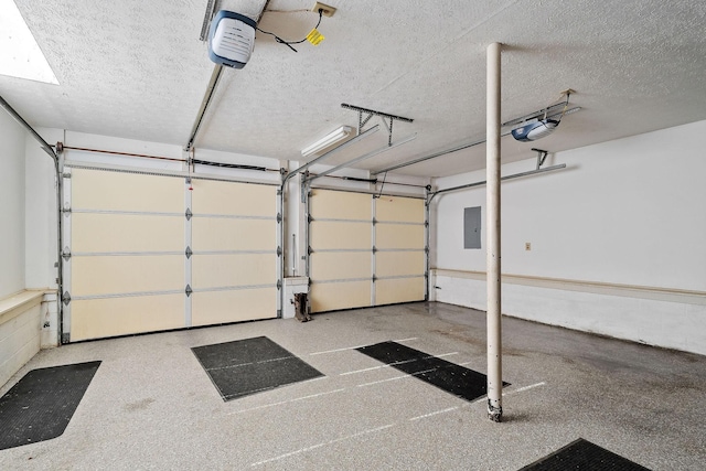 garage with electric panel and a garage door opener