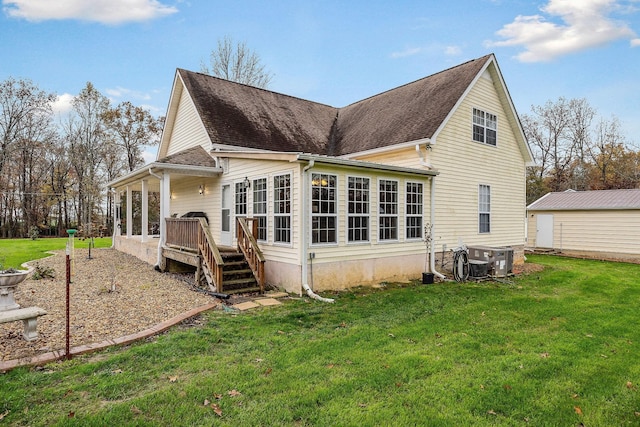 back of house with a wooden deck, a yard, and central AC