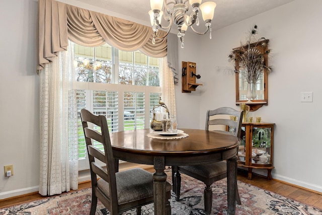 dining space featuring a notable chandelier and wood-type flooring