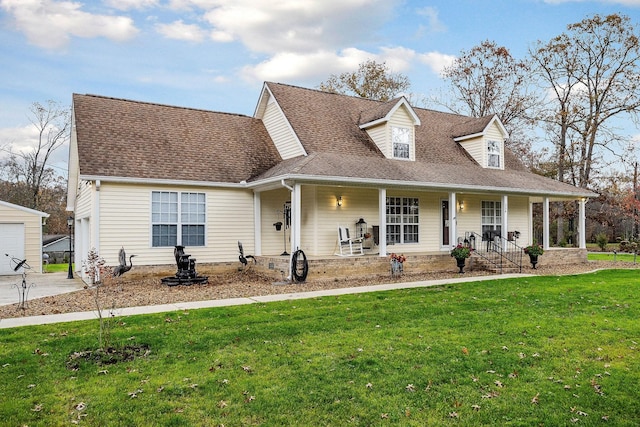 cape cod-style house with covered porch, a front yard, and a garage