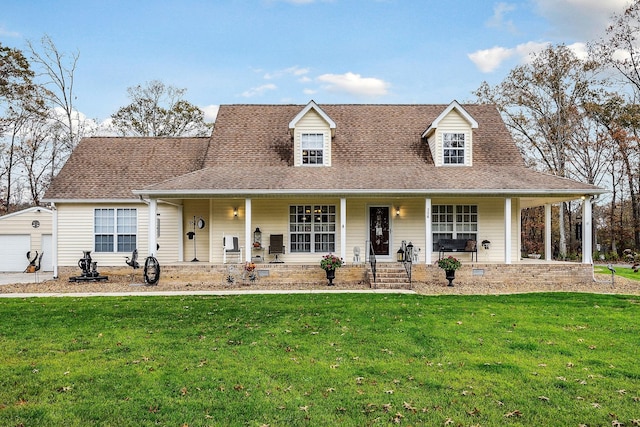 view of front of home with an outdoor structure, a porch, a front yard, and a garage