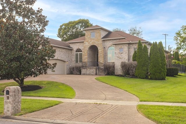 mediterranean / spanish-style house with a front lawn and a garage